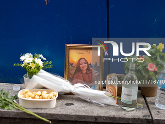 A memorial tribute for a victim of the Itaewon tragedy includes flowers, a framed photo, snacks, and drinks, placed in remembrance in the It...