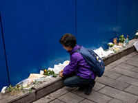 A bereaved family member places a flower after the billboard opening ceremony at the ''10.29 Path of Remembrance and Safety'' in the Itaewon...