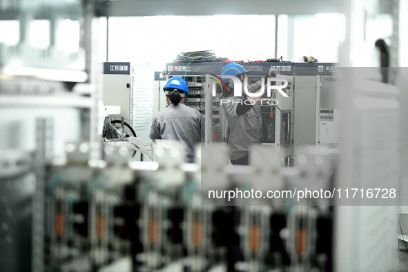 Workers produce power transmission equipment products at a workshop in Hai'an, Jiangsu province, China, on October 28, 2024. 