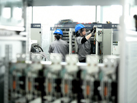 Workers produce power transmission equipment products at a workshop in Hai'an, Jiangsu province, China, on October 28, 2024. (