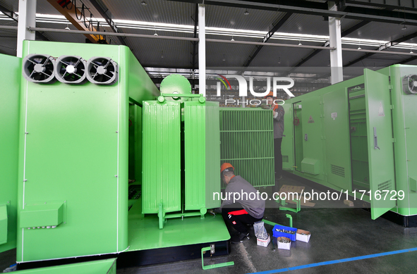 Workers produce power transmission equipment products at a workshop in Hai'an, Jiangsu province, China, on October 28, 2024. 