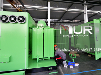 Workers produce power transmission equipment products at a workshop in Hai'an, Jiangsu province, China, on October 28, 2024. (