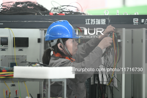 Workers produce power transmission equipment products at a workshop in Hai'an, Jiangsu province, China, on October 28, 2024. 