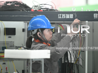 Workers produce power transmission equipment products at a workshop in Hai'an, Jiangsu province, China, on October 28, 2024. (