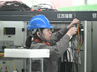 Workers produce power transmission equipment products at a workshop in Hai'an, Jiangsu province, China, on October 28, 2024. (