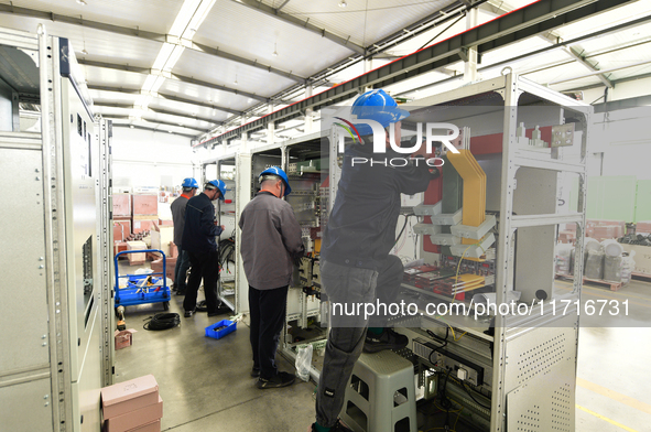 Workers produce power transmission equipment products at a workshop in Hai'an, Jiangsu province, China, on October 28, 2024. 