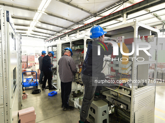 Workers produce power transmission equipment products at a workshop in Hai'an, Jiangsu province, China, on October 28, 2024. (