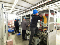 Workers produce power transmission equipment products at a workshop in Hai'an, Jiangsu province, China, on October 28, 2024. (