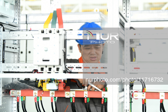 Workers produce power transmission equipment products at a workshop in Hai'an, Jiangsu province, China, on October 28, 2024. 