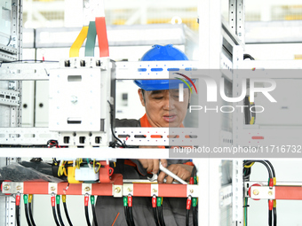 Workers produce power transmission equipment products at a workshop in Hai'an, Jiangsu province, China, on October 28, 2024. (