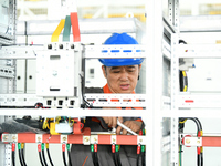 Workers produce power transmission equipment products at a workshop in Hai'an, Jiangsu province, China, on October 28, 2024. (