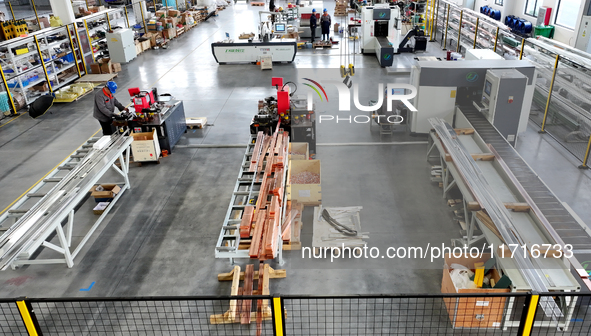 Workers produce power transmission equipment products at a workshop in Hai'an, Jiangsu province, China, on October 28, 2024. 