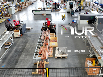 Workers produce power transmission equipment products at a workshop in Hai'an, Jiangsu province, China, on October 28, 2024. (