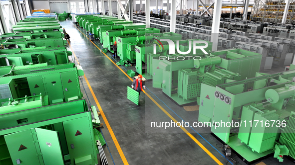 Workers produce power transmission equipment products at a workshop in Hai'an, Jiangsu province, China, on October 28, 2024. 