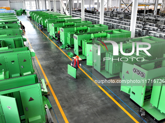 Workers produce power transmission equipment products at a workshop in Hai'an, Jiangsu province, China, on October 28, 2024. (