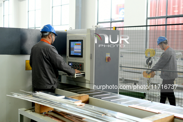 Workers produce power transmission equipment products at a workshop in Hai'an, Jiangsu province, China, on October 28, 2024. 