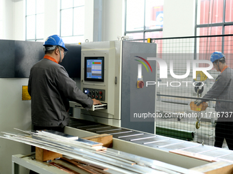 Workers produce power transmission equipment products at a workshop in Hai'an, Jiangsu province, China, on October 28, 2024. (