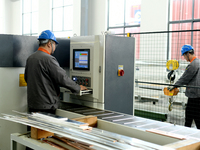 Workers produce power transmission equipment products at a workshop in Hai'an, Jiangsu province, China, on October 28, 2024. (