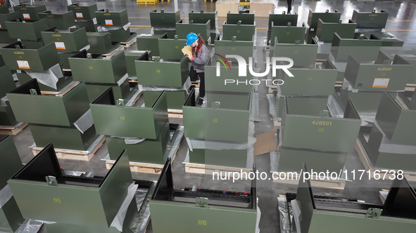 Workers produce power transmission equipment products at a workshop in Hai'an, Jiangsu province, China, on October 28, 2024. 