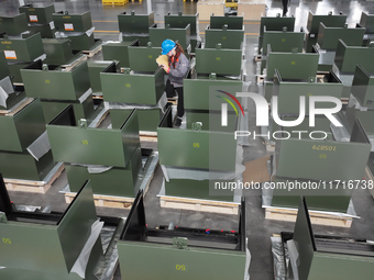 Workers produce power transmission equipment products at a workshop in Hai'an, Jiangsu province, China, on October 28, 2024. (