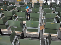 Workers produce power transmission equipment products at a workshop in Hai'an, Jiangsu province, China, on October 28, 2024. (