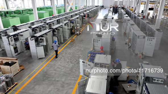 Workers produce power transmission equipment products at a workshop in Hai'an, Jiangsu province, China, on October 28, 2024. 