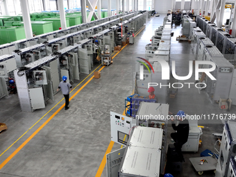 Workers produce power transmission equipment products at a workshop in Hai'an, Jiangsu province, China, on October 28, 2024. (