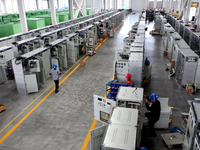 Workers produce power transmission equipment products at a workshop in Hai'an, Jiangsu province, China, on October 28, 2024. (