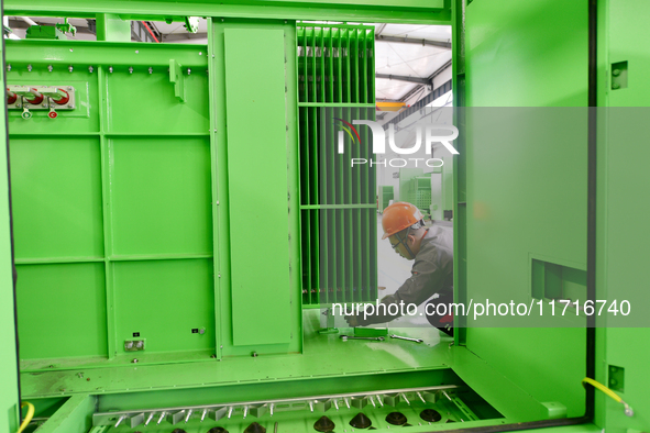 Workers produce power transmission equipment products at a workshop in Hai'an, Jiangsu province, China, on October 28, 2024. 