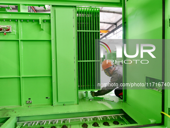 Workers produce power transmission equipment products at a workshop in Hai'an, Jiangsu province, China, on October 28, 2024. (