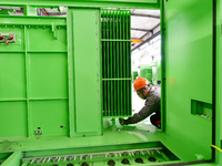 Workers produce power transmission equipment products at a workshop in Hai'an, Jiangsu province, China, on October 28, 2024. (