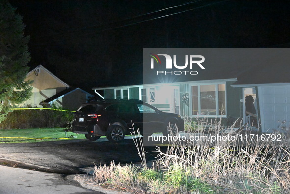 Police maintain a presence outside a home following the death of three people inside a home in Huntsville, Canada, on October 28, 2024. Earl...