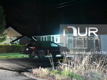 Police maintain a presence outside a home following the death of three people inside a home in Huntsville, Canada, on October 28, 2024. Earl...