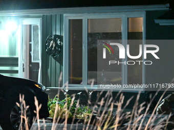 Police maintain a presence outside a home following the death of three people inside a home in Huntsville, Canada, on October 28, 2024. Earl...