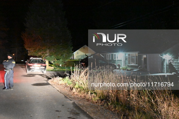 Police maintain a presence outside a home following the death of three people inside a home in Huntsville, Canada, on October 28, 2024. Earl...