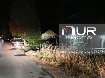 Police maintain a presence outside a home following the death of three people inside a home in Huntsville, Canada, on October 28, 2024. Earl...