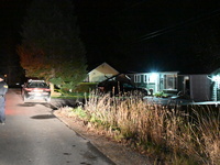 Police maintain a presence outside a home following the death of three people inside a home in Huntsville, Canada, on October 28, 2024. Earl...