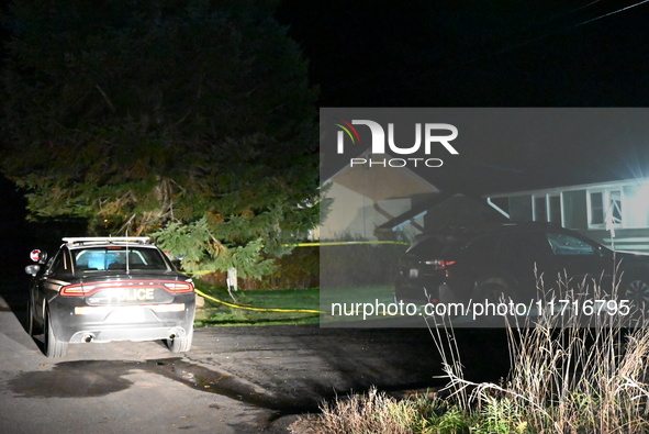 Police maintain a presence outside a home following the death of three people inside a home in Huntsville, Canada, on October 28, 2024. Earl...