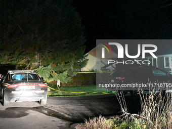 Police maintain a presence outside a home following the death of three people inside a home in Huntsville, Canada, on October 28, 2024. Earl...