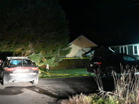 Police maintain a presence outside a home following the death of three people inside a home in Huntsville, Canada, on October 28, 2024. Earl...