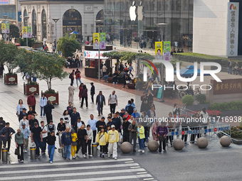 Chinese and foreign tourists bustle along the Nanjing Road Pedestrian Street in Shanghai, China, on October 28, 2024. (