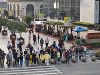 Chinese and foreign tourists bustle along the Nanjing Road Pedestrian Street in Shanghai, China, on October 28, 2024. (