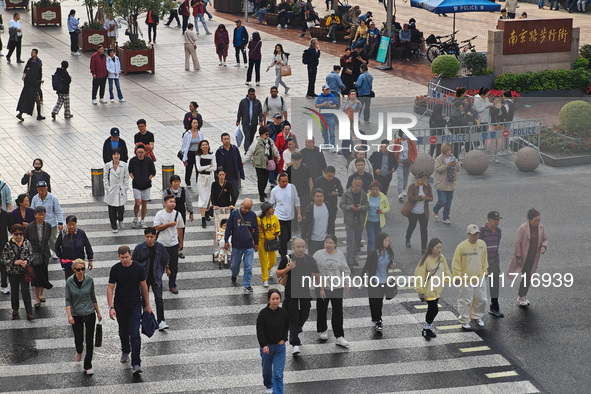 Chinese and foreign tourists bustle along the Nanjing Road Pedestrian Street in Shanghai, China, on October 28, 2024. 