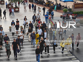 Chinese and foreign tourists bustle along the Nanjing Road Pedestrian Street in Shanghai, China, on October 28, 2024. (