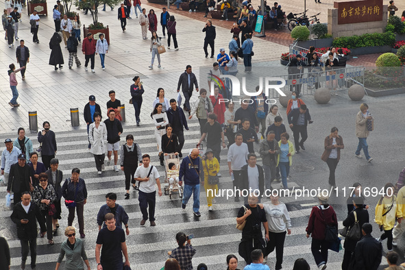 Chinese and foreign tourists bustle along the Nanjing Road Pedestrian Street in Shanghai, China, on October 28, 2024. 