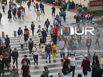 Chinese and foreign tourists bustle along the Nanjing Road Pedestrian Street in Shanghai, China, on October 28, 2024. (