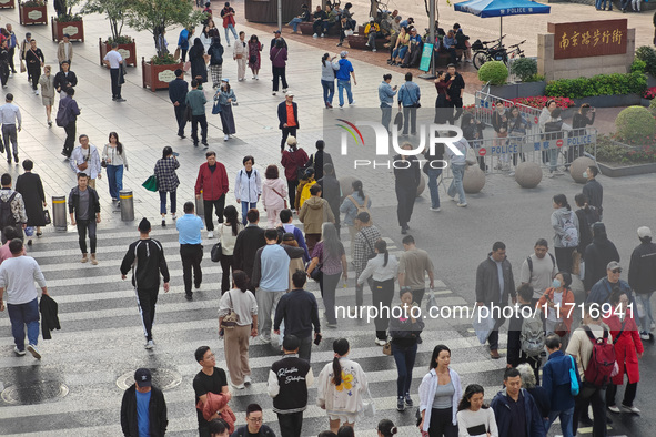 Chinese and foreign tourists bustle along the Nanjing Road Pedestrian Street in Shanghai, China, on October 28, 2024. 