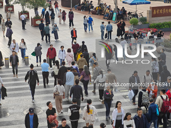 Chinese and foreign tourists bustle along the Nanjing Road Pedestrian Street in Shanghai, China, on October 28, 2024. (