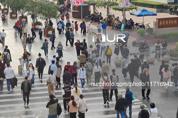 Chinese and foreign tourists bustle along the Nanjing Road Pedestrian Street in Shanghai, China, on October 28, 2024. 