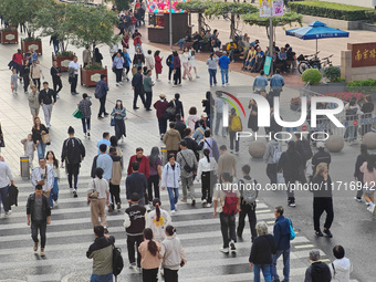 Chinese and foreign tourists bustle along the Nanjing Road Pedestrian Street in Shanghai, China, on October 28, 2024. (